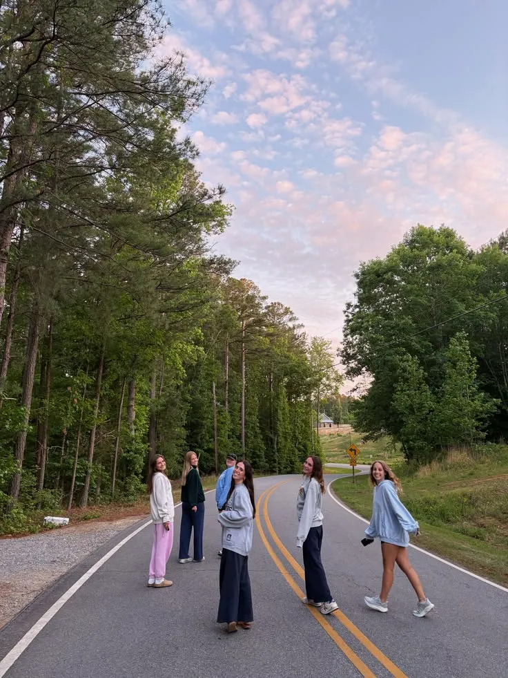 Group walking along a tree-lined street at dawn